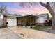 Charming home featuring a screened front porch, brick accents, attached garage, and a well-maintained front yard at 407 Ventura Dr, Sanford, FL 32773