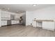 Bright kitchen area with stainless steel appliances, white cabinets, granite countertops, and stylish flooring at 407 Ventura Dr, Sanford, FL 32773