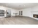 Spacious living room with an open floor plan, fireplace, stainless steel appliances, and French door access at 407 Ventura Dr, Sanford, FL 32773