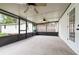 Spacious enclosed porch featuring dual ceiling fans and access to backyard and home, ideal for relaxing at 407 Ventura Dr, Sanford, FL 32773