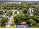 Aerial view of neighborhood highlighting a backyard deck, mature trees, a red property outline, and surrounding streets at 424 E Muriel St, Orlando, FL 32806