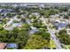 Aerial view with mature trees lining the streets in a neighborhood featuring a community pool, and well-kept homes at 424 E Muriel St, Orlando, FL 32806