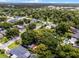 Overhead view of a home featuring a spacious backyard with a pool and deck, all enveloped by mature trees at 424 E Muriel St, Orlando, FL 32806