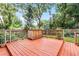 Wooden back deck with a built-in wooden cabinet offering storage and a surface for plants or decor at 424 E Muriel St, Orlando, FL 32806
