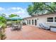 Wooden back deck offering an outdoor dining area with convenient access to the home's interior at 424 E Muriel St, Orlando, FL 32806