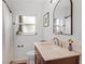 Bright bathroom featuring a wooden vanity with a marble countertop, and a large mirror at 424 E Muriel St, Orlando, FL 32806