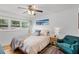 Comfortable bedroom with hardwood floors, large window, soft lighting, and a cozy sitting chair at 424 E Muriel St, Orlando, FL 32806