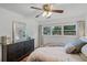 Bedroom with a dark dresser, large window, and soft lighting, creating a cozy and inviting space at 424 E Muriel St, Orlando, FL 32806