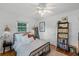 Bright bedroom featuring a metal bed frame, light-colored walls, and a bookshelf filled with books at 424 E Muriel St, Orlando, FL 32806