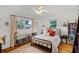 Charming bedroom featuring a metal bed frame, hardwood floors, and ample natural light from dual windows at 424 E Muriel St, Orlando, FL 32806