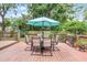 Wooden deck includes an outdoor dining set with a blue umbrella, plants, and wooden planters at 424 E Muriel St, Orlando, FL 32806