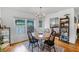 Cozy dining area leading to the kitchen, featuring a classic table set and natural light at 424 E Muriel St, Orlando, FL 32806