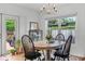 Charming dining area with a wooden table, classic chairs, and access to outdoor patio at 424 E Muriel St, Orlando, FL 32806