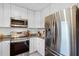 Modern kitchen with stainless steel appliances, granite countertops, and white cabinetry at 424 E Muriel St, Orlando, FL 32806