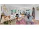 Bright and airy living room with hardwood floors, multiple seating areas, and access to the deck at 424 E Muriel St, Orlando, FL 32806