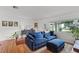 Comfortable living room with a plush blue sofa, natural light, and hardwood floors at 424 E Muriel St, Orlando, FL 32806