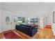Bright living room with hardwood floors, large window, and comfortable seating area at 424 E Muriel St, Orlando, FL 32806