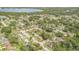 Extensive aerial view of a neighborhood with lush greenery and a beautiful lake in the distance at 436 Azores Ave, Orlando, FL 32811