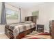 Inviting bedroom featuring a wooden bed frame and tile flooring with a unique rug at 436 Azores Ave, Orlando, FL 32811