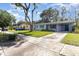 Cozy single-story home with a well-manicured lawn, carport and driveway providing ample parking space at 436 Azores Ave, Orlando, FL 32811