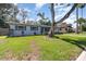 Single-story home with a well-maintained lawn and mature tree in a residential neighborhood at 436 Azores Ave, Orlando, FL 32811