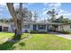 Single-story home featuring a well-maintained lawn and mature tree with plenty of curb appeal at 436 Azores Ave, Orlando, FL 32811