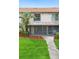 Charming two-story home features a screened-in back porch with lush landscaping and a well-maintained lawn at 5126 Saint Charles Ln # 43, Orlando, FL 32822