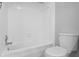 Bright bathroom featuring tiled walls surrounding the toilet and shower/tub combo at 5126 Saint Charles Ln # 43, Orlando, FL 32822