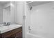 Bright bathroom featuring a shower/tub combo with tiled walls and a vanity sink at 5126 Saint Charles Ln # 43, Orlando, FL 32822