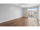 Bedroom with ceiling fan and a sliding glass door to the outdoors, laminate wood flooring at 5126 Saint Charles Ln # 43, Orlando, FL 32822