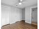 Bedroom featuring a ceiling fan, a closet, an entrance to the bathroom, and laminate wood flooring at 5126 Saint Charles Ln # 43, Orlando, FL 32822