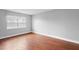Bright bedroom with hardwood floors and a large window for natural light at 5126 Saint Charles Ln # 43, Orlando, FL 32822