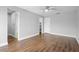 Bedroom featuring laminate wood flooring, a ceiling fan, and an entrance to the bathroom at 5126 Saint Charles Ln # 43, Orlando, FL 32822