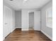 Bedroom with laminate wood flooring and featuring an entrance to the bathroom and a closet at 5126 Saint Charles Ln # 43, Orlando, FL 32822