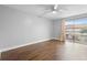 Bedroom with ceiling fan and a sliding glass door to the outdoors, laminate wood flooring at 5126 Saint Charles Ln # 43, Orlando, FL 32822