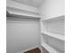 Spacious walk-in closet with multiple shelves and a hanging rod, ideal for organized storage at 5126 Saint Charles Ln # 43, Orlando, FL 32822
