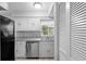 Clean kitchen featuring tile backsplash, stainless steel dishwasher and black refrigerator at 5126 Saint Charles Ln # 43, Orlando, FL 32822
