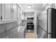 Well-lit kitchen featuring stainless steel appliances, granite counters, and sleek backsplash at 5126 Saint Charles Ln # 43, Orlando, FL 32822