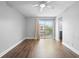 Bright living room with wood floors, ceiling fan, and sliding glass door providing ample natural light at 5126 Saint Charles Ln # 43, Orlando, FL 32822