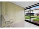 Relaxing screened patio with a chair and view of the well-maintained green lawn at 5126 Saint Charles Ln # 43, Orlando, FL 32822