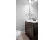 Powder room featuring toilet, vanity with a black faucet and decorative hardware at 5126 Saint Charles Ln # 43, Orlando, FL 32822