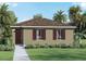 Charming single-story home with a well-manicured lawn and lush tropical landscaping at 5608 Paddock Fence Ln, Apopka, FL 32712
