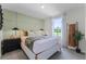 Stylish bedroom with accent wall, plush carpeting, stylish decor and large window overlooking the community at 6006 Galloping Dr, Apopka, FL 32712