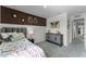 This bedroom has a decorative accent wall, storage cabinet, and plush carpet at 6006 Galloping Dr, Apopka, FL 32712