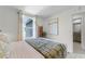 Bright bedroom featuring neutral walls, plush carpeting, stylish decor and en suite bathroom at 6006 Galloping Dr, Apopka, FL 32712