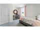 Comfortable bedroom with a charming desk, mirror, and a bright window with sheer curtains at 6006 Galloping Dr, Apopka, FL 32712