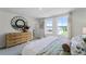 Bright bedroom featuring neutral walls, plush carpeting, stylish decor and large windows overlooking the community at 6006 Galloping Dr, Apopka, FL 32712