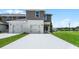 New two-story home featuring a two-car garage and a well-manicured lawn at 6006 Galloping Dr, Apopka, FL 32712