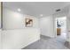 Bright hallway with art and closet, leading to carpeted rooms at 6006 Galloping Dr, Apopka, FL 32712