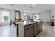 Open-concept kitchen with a large island, granite countertops, stainless steel appliances, and seamless flow to living spaces at 6006 Galloping Dr, Apopka, FL 32712